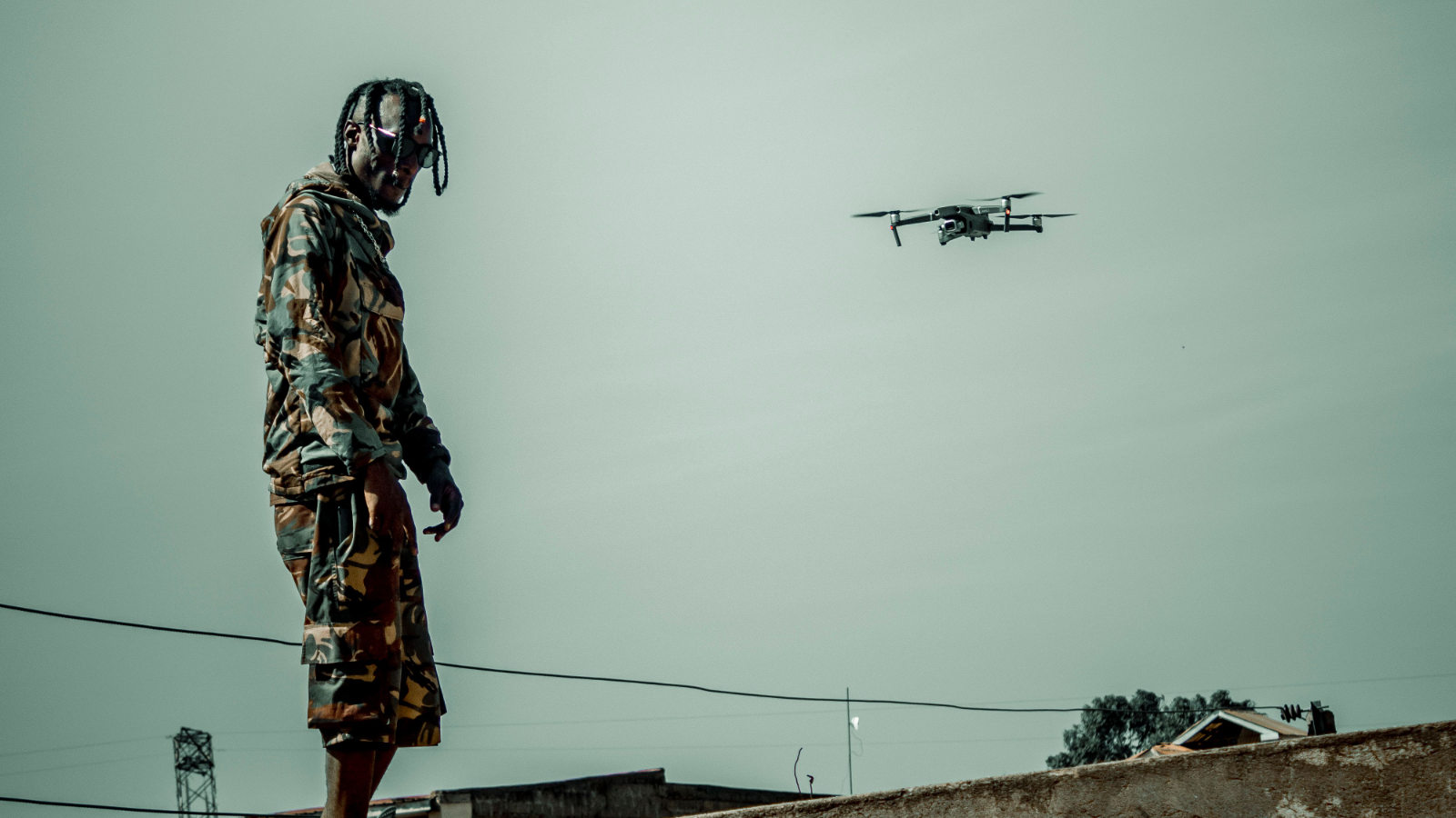 A commercial quadcopter over a rooftop.